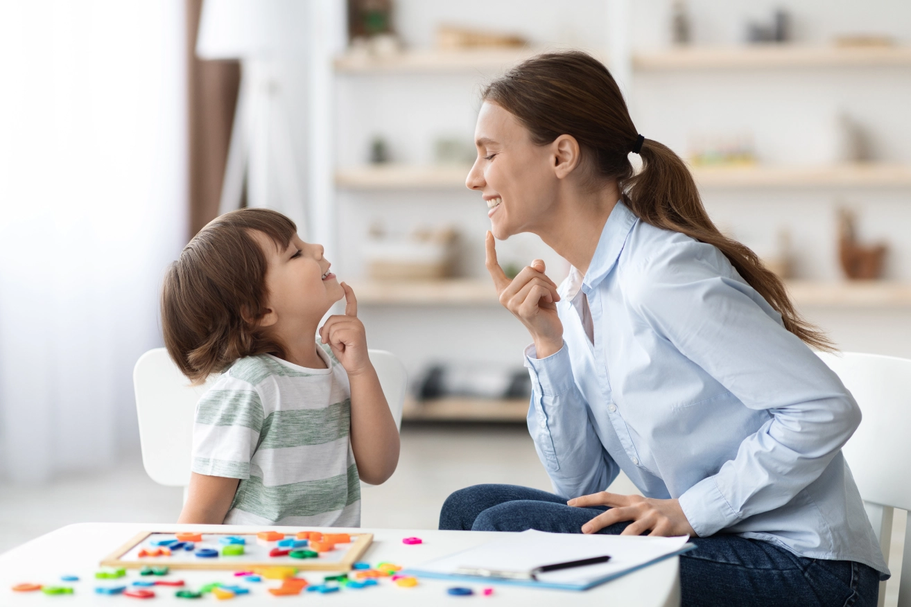 Speech therapist working with young child.